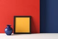 Black yellow Square empty frame mockup in Bauhaus style on red blue wall background, light gray floor and vase. Minimal style. Royalty Free Stock Photo