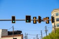 A black and yellow traffic signal with two green lights surrounded by buildings and blue sky in Atlanta Royalty Free Stock Photo