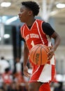 Black young boy holding and ready to pass the ball