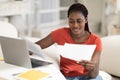 Black Young Freelancer Woman Working With Documents And Laptop At Home Office Royalty Free Stock Photo