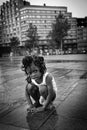 Black young girl on the Square of Flagey after the rain in a hot