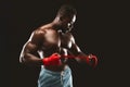 Black young kickboxer getting ready for fight