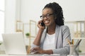 Black Young Lady Having Phone Conversation Sitting At Workplace Royalty Free Stock Photo