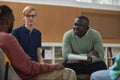 Black young man as mental health therapist in support group session Royalty Free Stock Photo