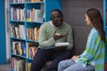 Black young man as mental health therapist talking to teenage girl Royalty Free Stock Photo