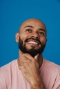 Black young man with beard smiling while holding his chin Royalty Free Stock Photo