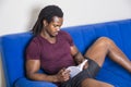 Black young man at home reading a book Royalty Free Stock Photo