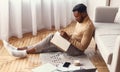 Young Man Taking Notes Studying Sitting On Floor At Home Royalty Free Stock Photo