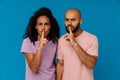 Black young man and woman making silence gesture at camera Royalty Free Stock Photo