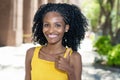 Black young woman from Brazil showing boths thumbs up