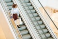 Black Young Woman on Escalator in Shopping Mall Royalty Free Stock Photo