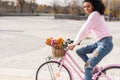 Black young woman riding a vintage bicycle Royalty Free Stock Photo