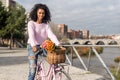 Black young woman riding a vintage bicycle Royalty Free Stock Photo