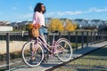 Black young woman riding a vintage bicycle Royalty Free Stock Photo