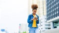 Black young woman, using smart phone and smile with walking in the city outdoor Royalty Free Stock Photo