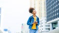 Black young woman using smart phone and smile with walking in the city outdoor Royalty Free Stock Photo