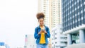 Black young woman, using smart phone and smile with walking in the city outdoor Royalty Free Stock Photo