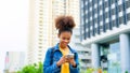 Black young woman, using smart phone and smile with walking in the city outdoor Royalty Free Stock Photo