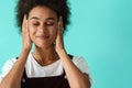 Black young woman wearing rings covering her ears