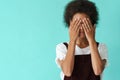 Black young woman wearing rings covering her eyes