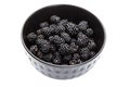 Blackberries in a black bowl, ripe fresh berries macro photo