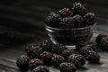 Blackberries on a dark background in bowls Royalty Free Stock Photo