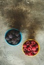 Blackberries and Raspberries in Ceramic Bowls on Rustic Stone Background Royalty Free Stock Photo
