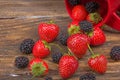 blackberries, strawberrieson wooden table background, spilled from a spice jar. Antioxidants, detox diet, organic fruits. Berries