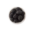 Blackberries in a white bowl. Berries with copy space for text. Ripe and tasty berry isolated on white.