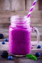 Blackberry and blueberry smoothie in a mason jar on a wooden background Royalty Free Stock Photo