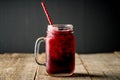 Blackberry cocktail with crushed ice in glass jar on the rustic wooden background. Selective focus. Shallow depth of field Royalty Free Stock Photo