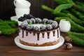 Blackberry cream mousse cake no baked cheesecake with chocolate glaze and frozen blackberry on top on a white plate Royalty Free Stock Photo