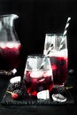 Blackberry drink in glasses with black sugar rim for fall and halloween parties.