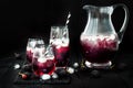 Blackberry drink in glasses with black sugar rim for fall and halloween parties. Royalty Free Stock Photo