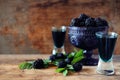 Blackberry fruit liqueur in two shot glasses with berries and gr Royalty Free Stock Photo