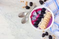 Blackberry smoothie bowl, corner border on a white marble background