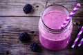 Blackberry smoothie in a mason jar on a wooden background Royalty Free Stock Photo