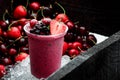 Blackberry strawberry smoothie in a wooden box with a cherry. close up Royalty Free Stock Photo