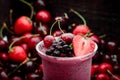 Blackberry strawberry smoothie in a wooden box with a cherry. close up Royalty Free Stock Photo