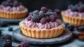 Blackberry tart with pink whipped cream on rustic plate