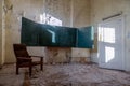 A blackboard in an abandoned school. An old abandoned school. Shabby walls. Armchair in the room.