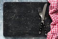 Blackboard or black cutting board and cutlery, food background Royalty Free Stock Photo