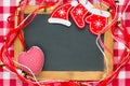 Blackboard blank framed in red Christmas decorations