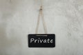 blackboard, chalkboard with text Private on grey cement wall Royalty Free Stock Photo