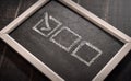 Blackboard with check boxes on chalk board. Hand writing. Dark background Royalty Free Stock Photo