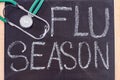 Blackboard with flu season handwriting and stethoscope.
