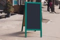 Blackboard in front of restaurant entrance. Mock up menu blank board sign stand near shop or cafe restaurant. Street Royalty Free Stock Photo