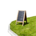 Blackboard on green grass isolated on white background with clipping path Royalty Free Stock Photo