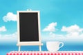 Blackboard menu with coffee cup display on fabric tabletop with Royalty Free Stock Photo