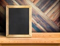 Blackboard on plank wooden table top at diagonal tropical wood wall,Template mock up for adding your design and leave space beside Royalty Free Stock Photo